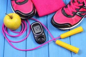 Glucose meter with result of sugar level, sport shoes, apple and accessories for fitness or sport, diabetes, healthy and active lifestyles